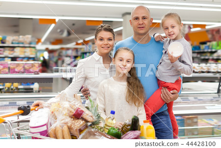 Cheerful kids and parents with purchases Cheerful kids and parents with purchases 44428100