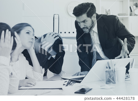 Outraged manager with colleagues at meeting 44428178