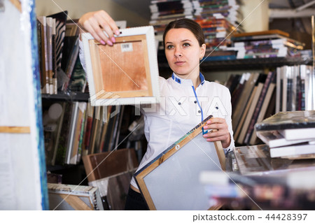 Woman buying wall picture 44428397