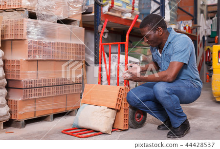 Adult African-American man with handbarrow Adult African-American man with handbarrow 44428537
