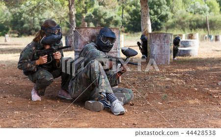 Paintball players of opposite teams in shootout 44428538