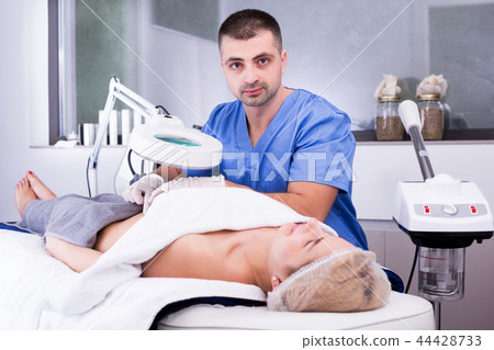 cosmetologist examining female body before procedure cosmetologist examining female body before procedure 44428733