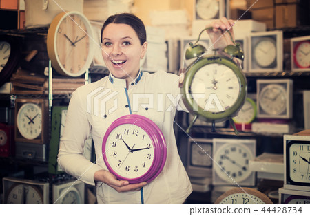 Beautiful woman is standing with modern clock 44428734