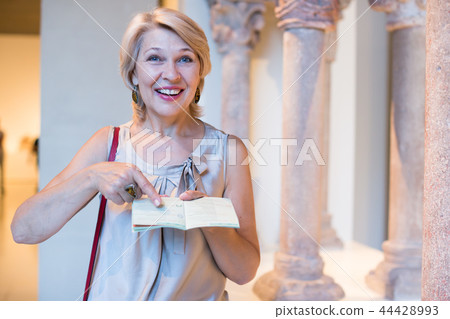 female visitor with guide book in the museum female visitor with guide book in the museum 44428993