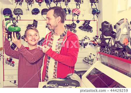 Son shows rollers to his father Son shows rollers to his father 44429259