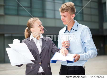 Young businessman and his colleague are reading documents 44429261