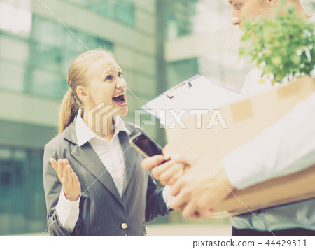 Serious businesswoman is dissatisfied of the results work of young manager Serious businesswoman is dissatisfied of the results work of young manager 44429311