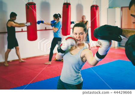 Girl sparring at box class Girl sparring at box class 44429666