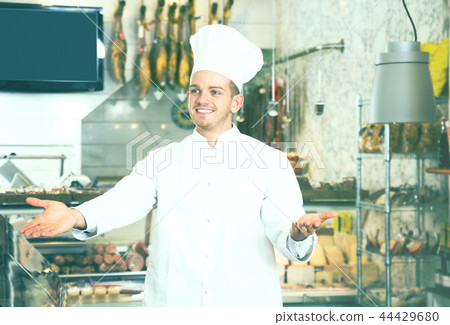 Seller in his grocery shop welcoming customers Seller in his grocery shop welcoming customers 44429680