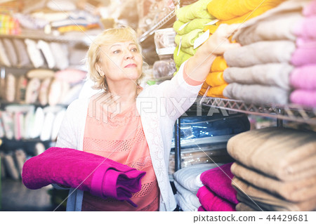 elderly female with bath towel in the shop elderly female with bath towel in the shop 44429681