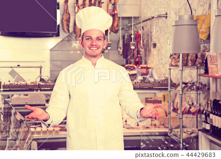 Seller in his grocery shop welcoming customers Seller in his grocery shop welcoming customers 44429683