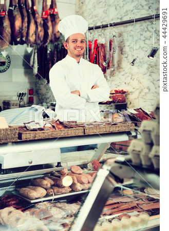 Seller in his grocery shop welcoming customers Seller in his grocery shop welcoming customers 44429691