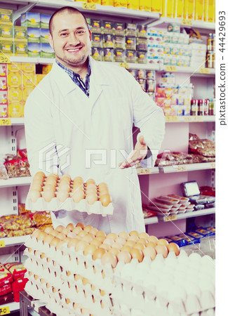 Man selling eggs in marketplace. Man selling eggs in marketplace. 44429693