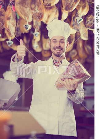 Seller offering piece of meat Seller offering piece of meat 44429695