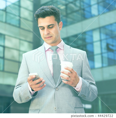 Successful businessman using phone Successful businessman using phone 44429722