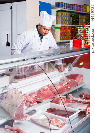 Portrait of male butcher in kosher section at supermarket Portrait of male butcher in kosher section at supermarket 44429723