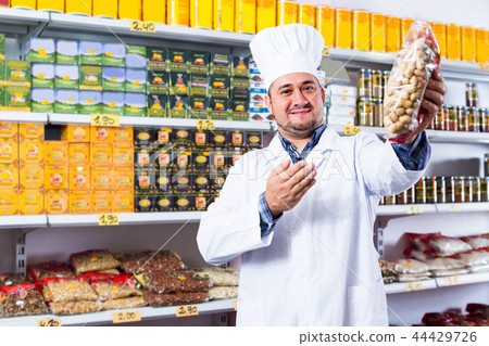 Salesman standing in food shop Salesman standing in food shop 44429726