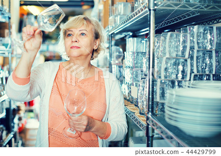female consumer choosing wineglass female consumer choosing wineglass 44429799