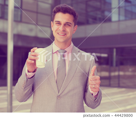 Smiling businessman showing thumbs up Smiling businessman showing thumbs up 44429800