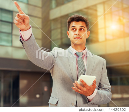 Businessman pointing at something Businessman pointing at something 44429802