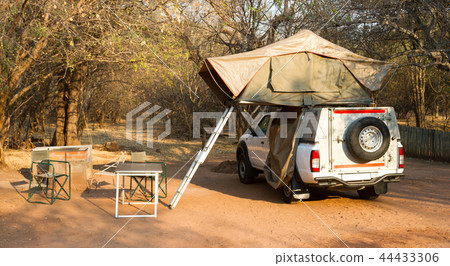 Offroad 4x4 vehicle with tent in the roof Offroad 4x4 vehicle with tent in the roof 44433306