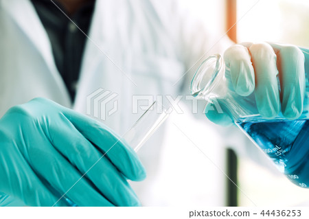 Close up scientist hand filling test tubes and res Close up scientist hand filling test tubes and res 44436253