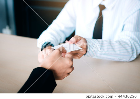 Hand of two business people sitting in office room Hand of two business people sitting in office room 44436256