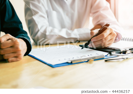 Man signing a contract with financial advisor Man signing a contract with financial advisor 44436257