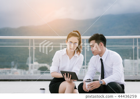 People using digital tablet at outside business 44436259