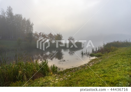 Sunrise over mist a tranquil lake with reflections Sunrise over mist a tranquil lake with reflections 44436716