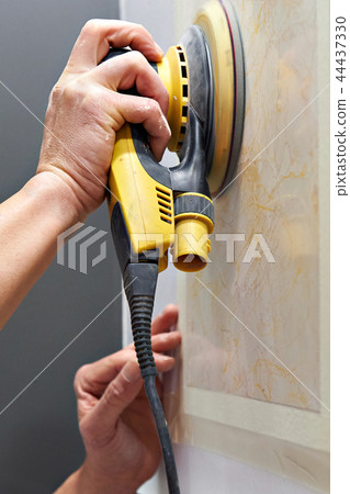 Grinding wall panel in repair of house 44437330
