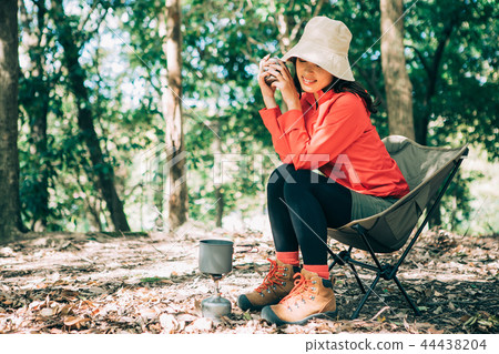 Woman drinking coffee in the mountains Woman drinking coffee in the mountains 44438204
