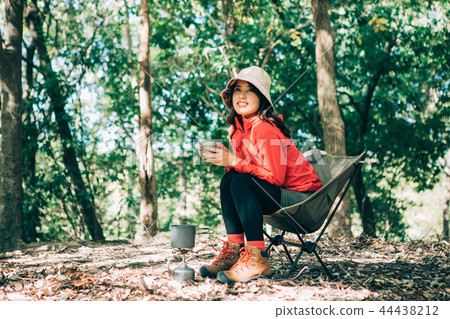 Woman drinking coffee in the mountains Woman drinking coffee in the mountains 44438212