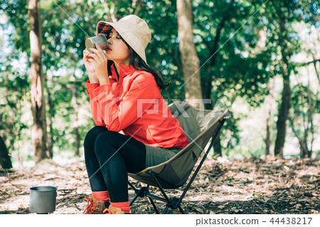 Woman drinking coffee in the mountains Woman drinking coffee in the mountains 44438217