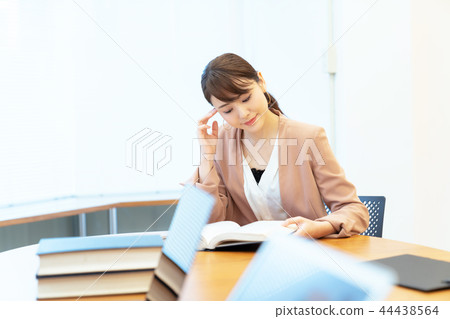 A woman reading a book A woman reading a book 44438564