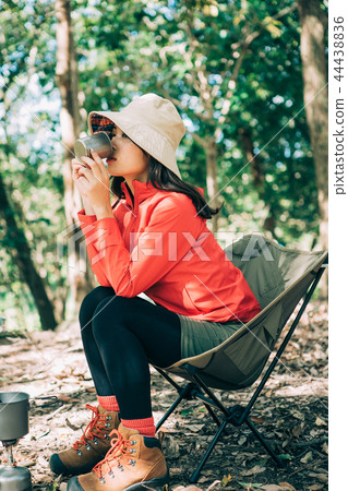 Woman drinking coffee at campsite Woman drinking coffee at campsite 44438836