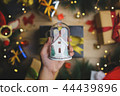 Hand Holding Christmas Glass Ornament 44439896