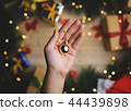 Hand Holding Small Gold Bauble Christmas 44439898