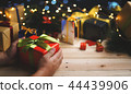 Hand Holding Red Green Christmas Present Gift 44439906
