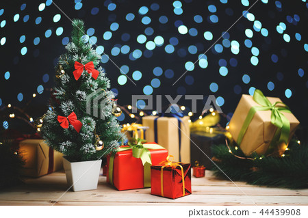 Small Christmas Tree Between Christmas Presents 44439908