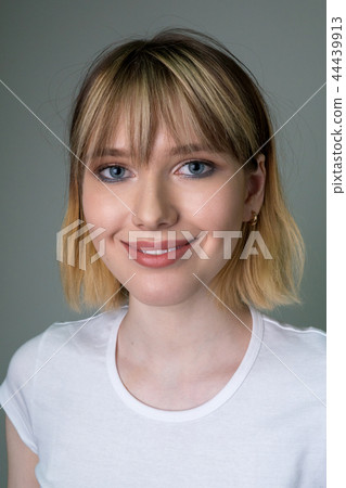 Portrait of a beautiful girl with short blond hair. Portrait of a beautiful girl with short blond hair. 44439913