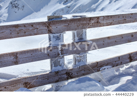 Wooden fence deep in heavy snow load  44440229