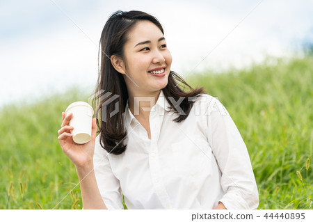 A woman drinking coffee A woman drinking coffee 44440895