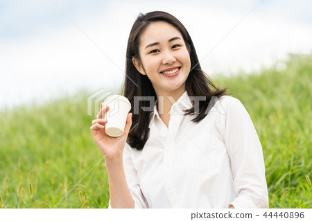 A woman drinking coffee A woman drinking coffee 44440896
