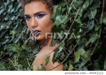 Girl with professional make up, seductive looking at side wrapping in green ivy. Girl with professional make up, seductive looking at side wrapping in green ivy. 44441212