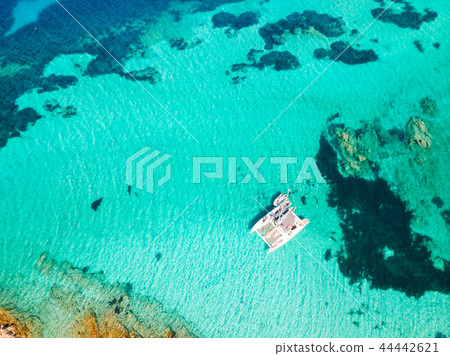 Drone aerial view of catamaran sailing boat in Maddalena Archipelago, Sardinia, Italy. 44442621