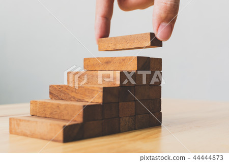 Hand arranging wood block stacking as step stair Hand arranging wood block stacking as step stair 44444873