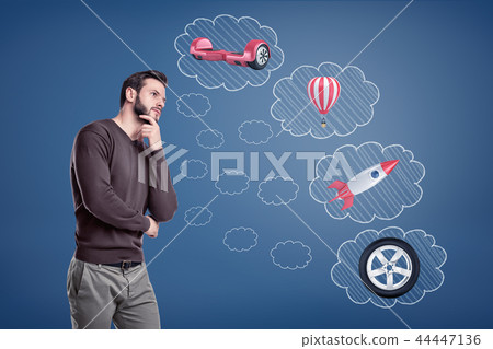 A thinking man stands near thought bubbles filled with a rocket, a car tire, a hot gas balloon and a 44447136
