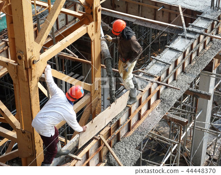 Concreting work by construction workers Concreting work by construction workers 44448370