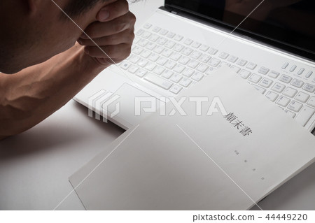 A man who is annoyed in front of a computer A man who is annoyed in front of a computer 44449220